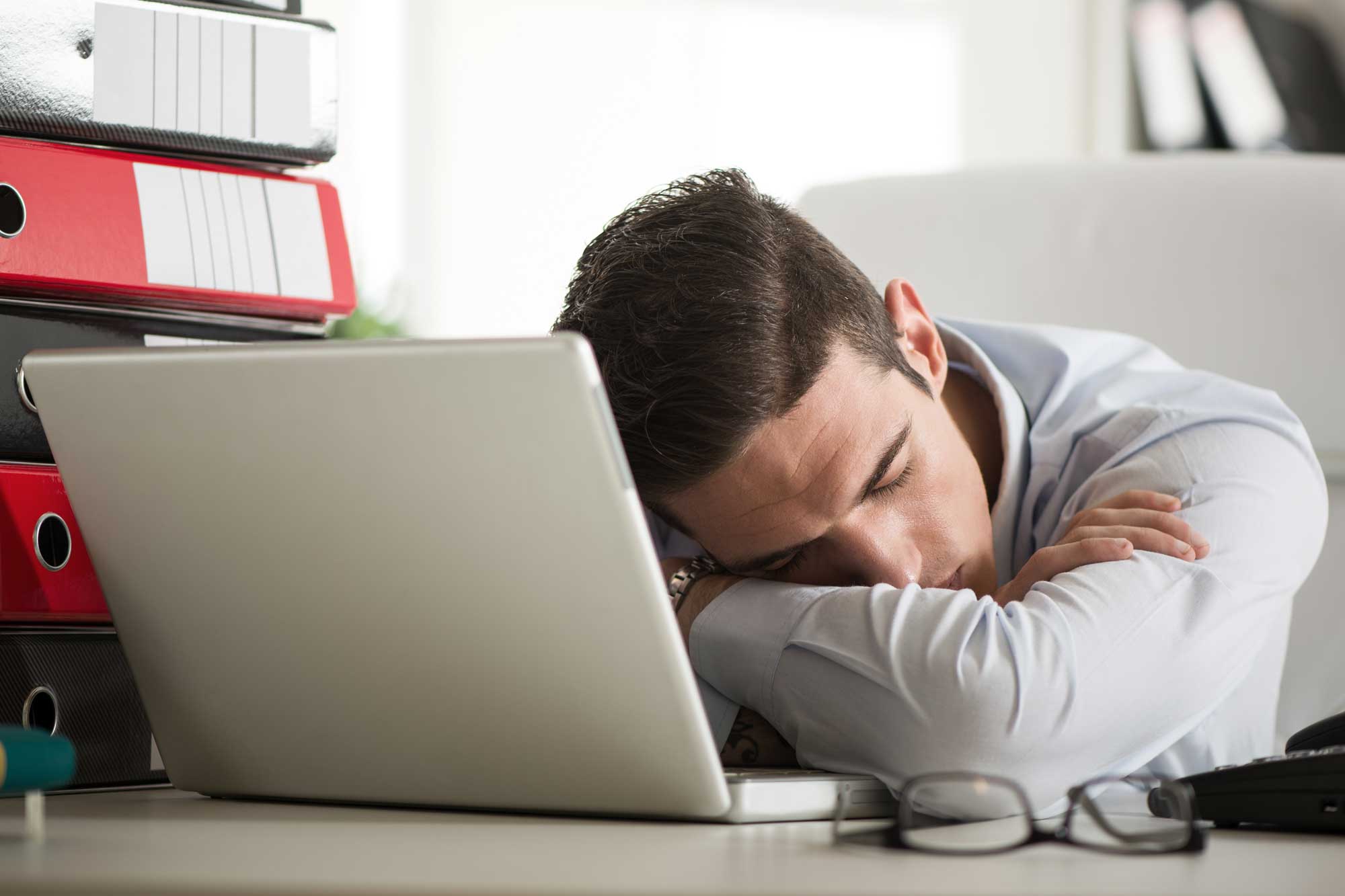 Businessman Sleeps at Desk